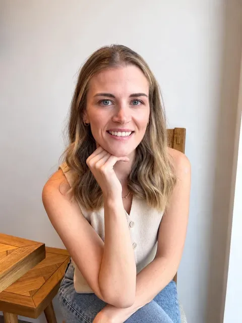 Ellis sitting at a wooden table, smiling